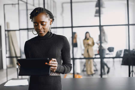 Portrait of a confident black businesswoman working at officeの写真素材