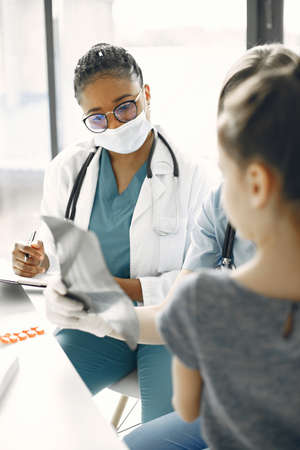Doctor examines a little girl in hospitalの写真素材