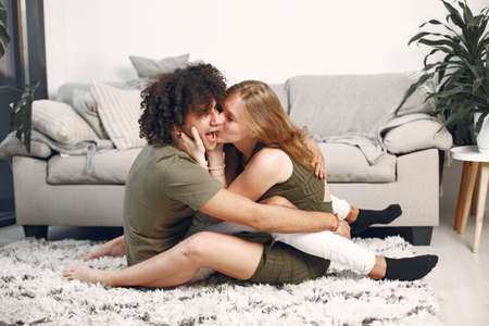 Multiracial couple in love on the floorの写真素材