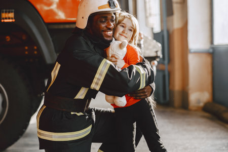 Portrait of a firefighter standing in front of a fire engineの写真素材
