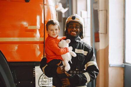 Portrait of a firefighter standing in front of a fire engine
