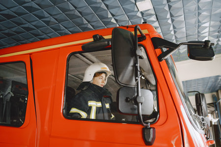 Firefighters in a fire truck in uniform