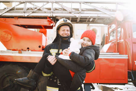 Male firefighter rescued a child and a toyの写真素材