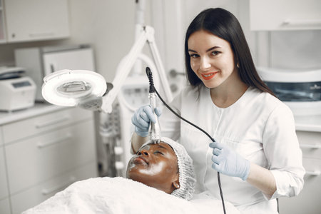 Girl doing facial procedures to beautician