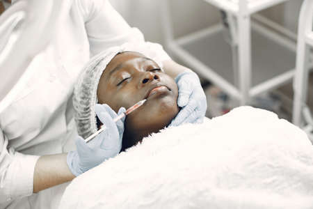 Girl doing facial procedures to beauticianの写真素材