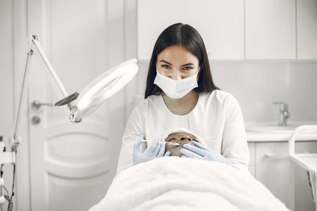 Girl doing facial procedures to beautician