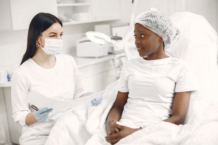 Beautician consults an african girl in office