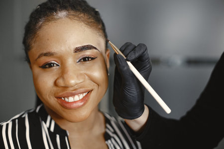 African girl doing eyebrow correction