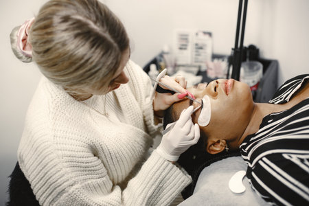 African girl grows eyelashes in salon
