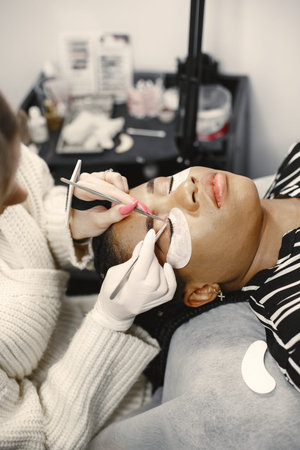 African girl grows eyelashes in salon