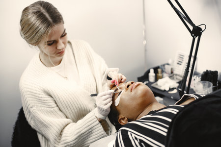 African girl grows eyelashes in salon