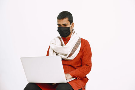 Man in protective mask work with laptop