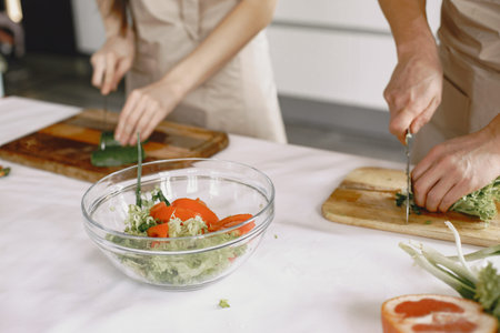 Happy asian couple have fun in modern kitchen indoorの写真素材