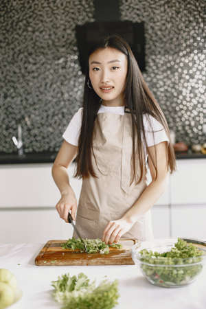 Asian woman prepare dinner in a kitchenの写真素材