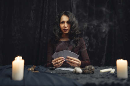 Portrait of fortune-teller in a dark roomの写真素材