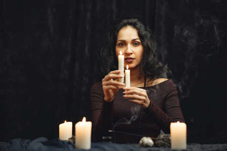 Portrait of fortune-teller in a dark roomの写真素材