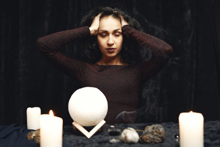Portrait of fortune-teller in a dark room