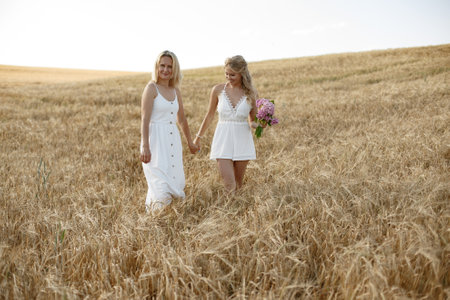 Mother with beautiful daughter in a autumn fieldの写真素材
