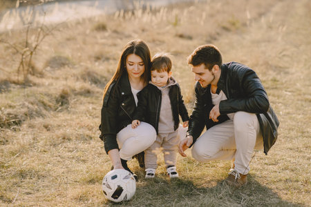 Stylish family walking on a spring fieldの写真素材