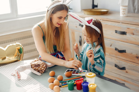 Mother with little daughter in a kitchen