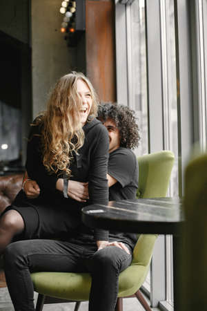 Mixed couple spenting time together in a cafeの写真素材