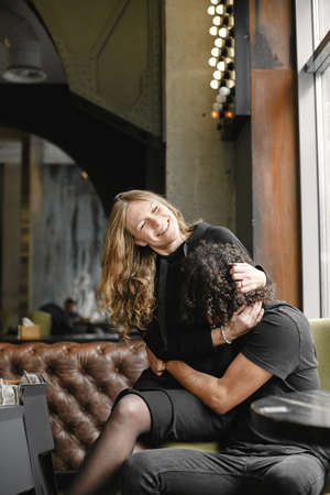 Mixed couple spenting time together in a cafeの写真素材