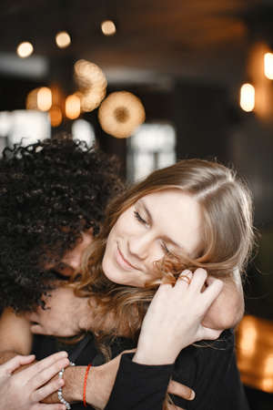 Mixed couple spenting time together in a cafeの写真素材