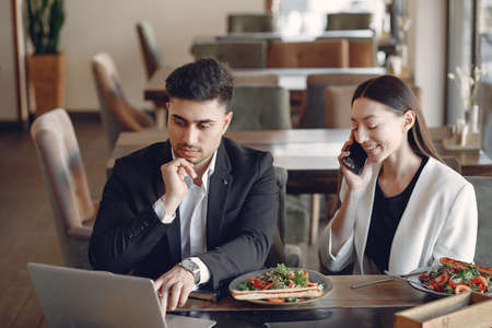 Stylish businessman working in a office and use the phoneの写真素材