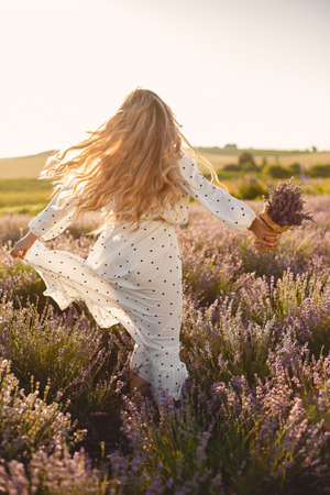 Woman in a white dress in a lavender fieldの写真素材