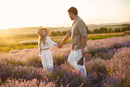 Woman in a white dress with her husband in a lavender fieldの写真素材