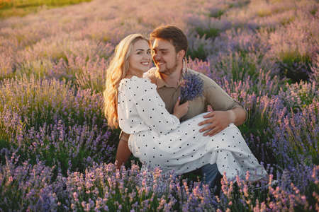 Woman in a white dress with her husband in a lavender fieldの写真素材