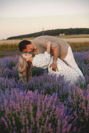 Woman in a white dress with her husband in a lavender fieldの写真素材