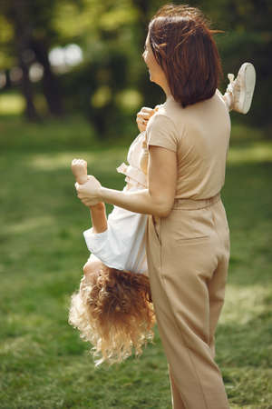 Elegant mother with daughter in a summer forestの写真素材