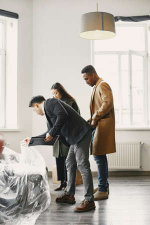 Real estate agent with customers checking apartmnetの写真素材