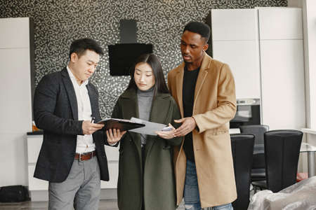 Realtor Explaining Agreement To Couple In New Apartmentの写真素材