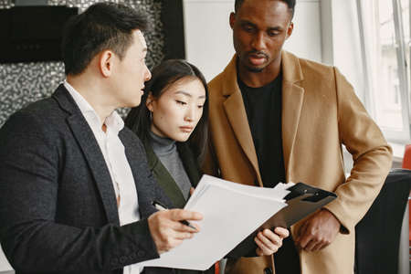 Realtor Explaining Agreement To Couple In New Apartmentの写真素材