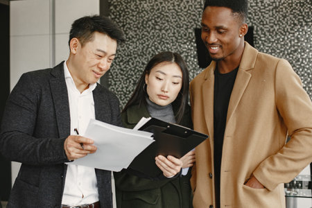 Realtor Explaining Agreement To Couple In New Apartmentの写真素材