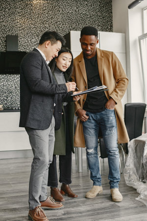 Couple discussing with designer or rieltor apartment projectの写真素材