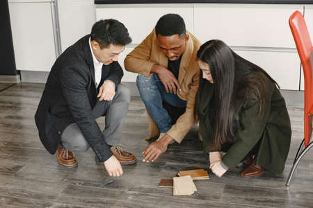 Couple discussing with designer or rieltor apartment projectの写真素材