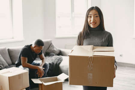 Couple unpacking boxes at their new homeの写真素材