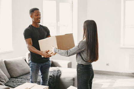 Couple unpacking boxes at their new home