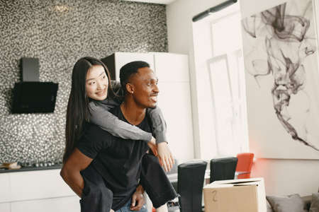 Happy couple have fun in their new apartmentの写真素材