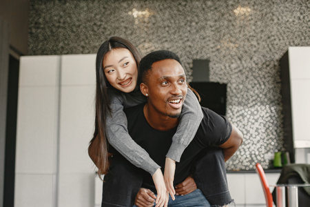 Happy couple have fun in their new apartmentの写真素材