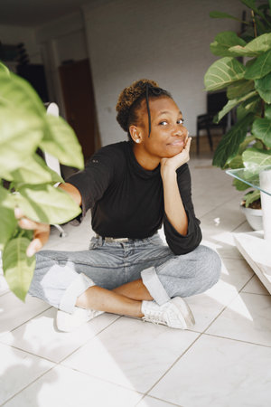 African woman with green big plantの写真素材