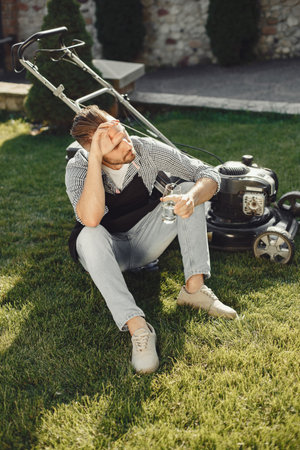 Lawn mower man working on the backyardの写真素材