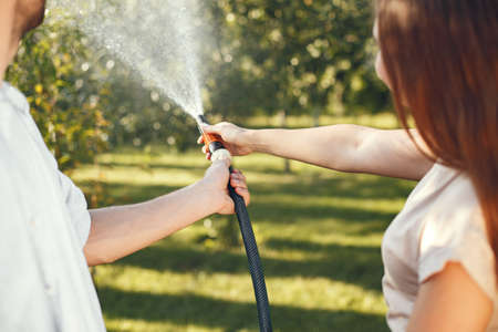 People watering grass in the gardenの写真素材