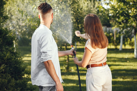 People watering grass in the garden