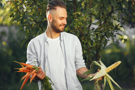 Portrait of smiling farmer holding vegetables in his hand