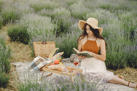 Woman in a straw hat in a lavender fieldの写真素材