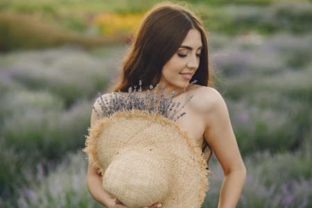 Woman without bra standing in a lavender fieldの写真素材